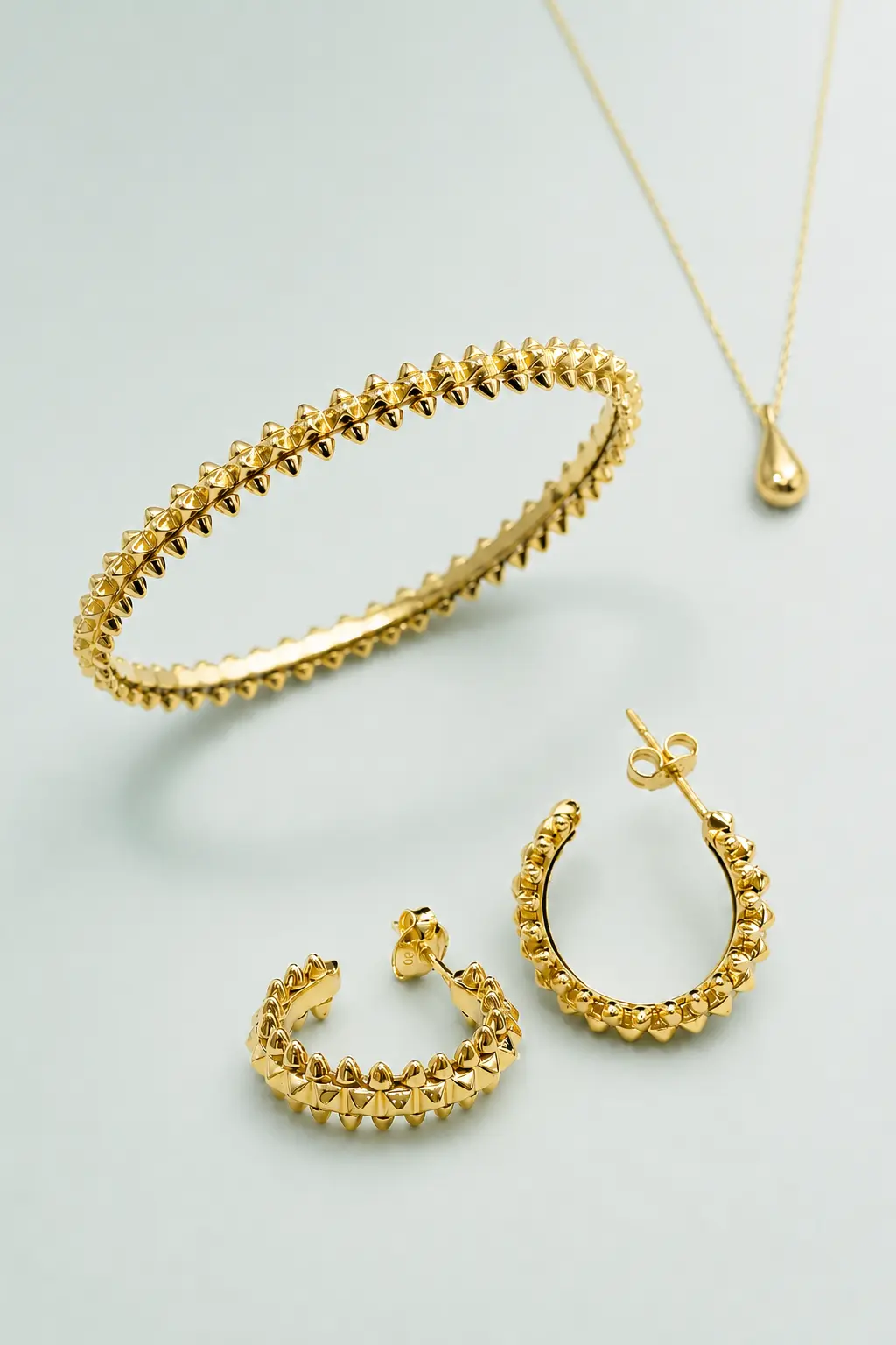 Gold necklace, bangle and earrings from the VAULTRADE Fine B2B collection direction